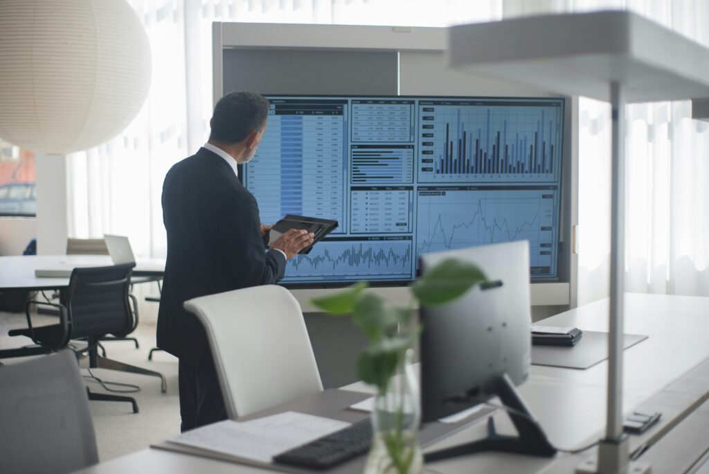 A Data Analyst looking into Dashboard in his office